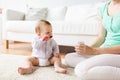 Mother and baby with spoon eating puree at home Royalty Free Stock Photo