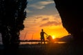 Mother with baby in stroller enjoying motherhood at sunset