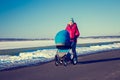 Mother with Baby Stroller Walking in Winter Park Royalty Free Stock Photo