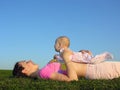 Mother with baby on sunset lie Royalty Free Stock Photo