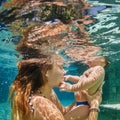 Mother, baby swim and dive underwater in swimming pool Royalty Free Stock Photo