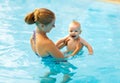 Mother and baby swim in pool Royalty Free Stock Photo