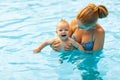 Mother and baby swim in pool Royalty Free Stock Photo