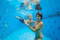 Mother with baby swimming, diving underwater in pool Royalty Free Stock Photo