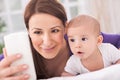 Mother and baby talking with father on phone Royalty Free Stock Photo