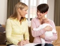 Mother With Baby Talking With Health Visitor Royalty Free Stock Photo