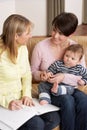 Mother With Baby Talking With Health Visitor Royalty Free Stock Photo