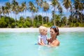 Mother and baby on tropical beach. Kids swim. Royalty Free Stock Photo