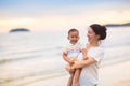 Mother and baby on tropical beach at sunset Royalty Free Stock Photo