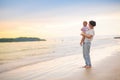 Mother and baby on tropical beach at sunset Royalty Free Stock Photo