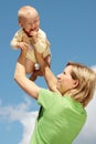 Mother with baby under blue sky Royalty Free Stock Photo