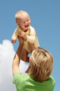 Mother with baby under blue sky Royalty Free Stock Photo