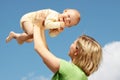 Mother with baby under blue sky Royalty Free Stock Photo