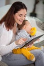 mother with baby using digital tablet at home Royalty Free Stock Photo