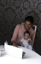 Mother and baby using laptop Royalty Free Stock Photo