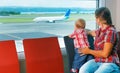 Mother with baby wait for boarding to flight in airport Royalty Free Stock Photo