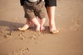 Mother and baby walking on beach Royalty Free Stock Photo