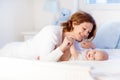 Mother and baby on a white bed Royalty Free Stock Photo