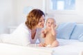 Mother and baby on a white bed Royalty Free Stock Photo