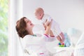 Mother and baby in white bedroom Royalty Free Stock Photo