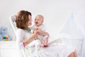 Mother and baby in white bedroom Royalty Free Stock Photo