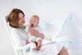 Mother and baby in white bedroom Royalty Free Stock Photo