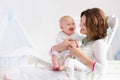 Mother and baby in white bedroom Royalty Free Stock Photo