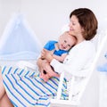 Mother and baby in white bedroom Royalty Free Stock Photo