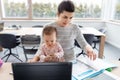 Mother with baby working at home office Royalty Free Stock Photo