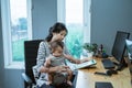 Mother babysit her infant baby while working Royalty Free Stock Photo