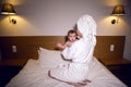 Mother in a bathrobe lying on bed Royalty Free Stock Photo