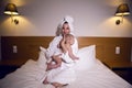 Mother in a bathrobe lying on bed Royalty Free Stock Photo