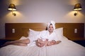 Mother in a bathrobe lying on bed Royalty Free Stock Photo