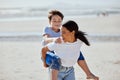 Mother, beach piggyback and asian child with smile, family bonding and outdoor vacation in sunshine. Happy family