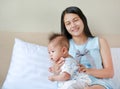 Mother is belching for infant baby after breastfeeding at bedroom Royalty Free Stock Photo