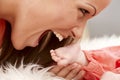 Mother biting baby foot Royalty Free Stock Photo