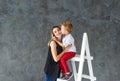 Mother and blond son on a step-ladder Royalty Free Stock Photo