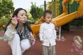 Mother blowing bubbles for son