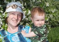 Mother and boy beside flowering aple tree Royalty Free Stock Photo