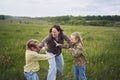 mother breaks up the children who are fighting in the rain in the field