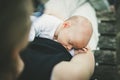 Mother breast feeding and hugging her baby boy outdoors. Royalty Free Stock Photo