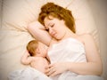 Mother is breast feeding newborn baby and dreami