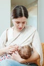 Mother breast feeding three-month baby