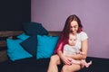 Mother breastfeeding baby in her arms at home. Beautiful mom Red hair breast feeding her newborn child. Young woman Royalty Free Stock Photo