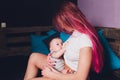 Mother breastfeeding baby in her arms at home. Beautiful mom Red hair breast feeding her newborn child. Young woman Royalty Free Stock Photo