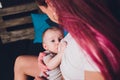 Mother breastfeeding baby in her arms at home. Beautiful mom Red hair breast feeding her newborn child. Young woman Royalty Free Stock Photo