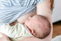 Mother breastfeeding a baby. Maternity love, babycare concept. Woman breastfeeding her newborn baby at home. Peaceful Royalty Free Stock Photo