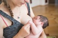 The mother is breastfeeding the baby. mother breastfeeds and hugs the baby, close-up breast. Mom breastfeeds her newborn baby. Royalty Free Stock Photo