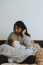 Mother breastfeeding her baby on the bed Royalty Free Stock Photo