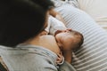 Mother breastfeeding her baby on the bed Royalty Free Stock Photo